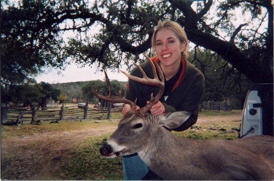 Woman with deer antlers in a rural setting