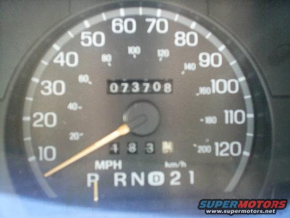 Close-up of a car's dashboard showing the odometer at 073708 and the speedometer