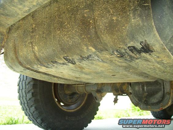 Underside view of vehicle showing fuel tank and rear axle assembly