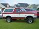 1988 Ford Bronco - Two-tone red and white 1988 Ford Bronco in a residential setting.