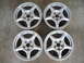 1994 Ford Probe - A set of four silver alloy wheels are displayed on a concrete surface.