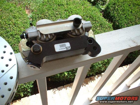 Brake caliper and slotted rotor on a railing