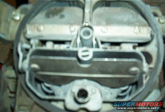 Carburetor with metal plates and springs visible