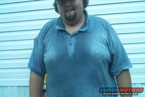 Man in blue polo shirt against light blue siding