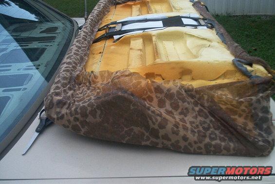 Car seat foam and leopard-print fabric cover on a car's hood