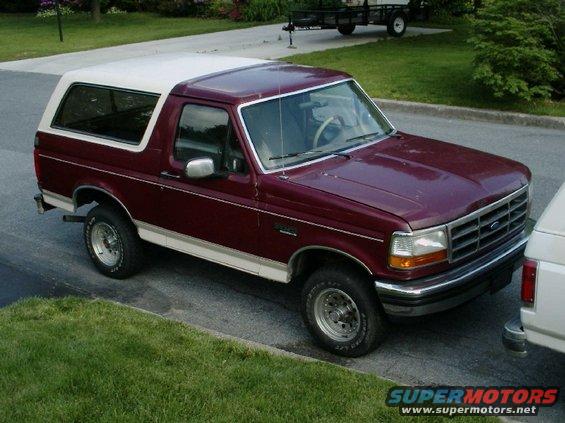 Maroon and white 1992 Ford Bronco parked on a street, viewed from the front-right
