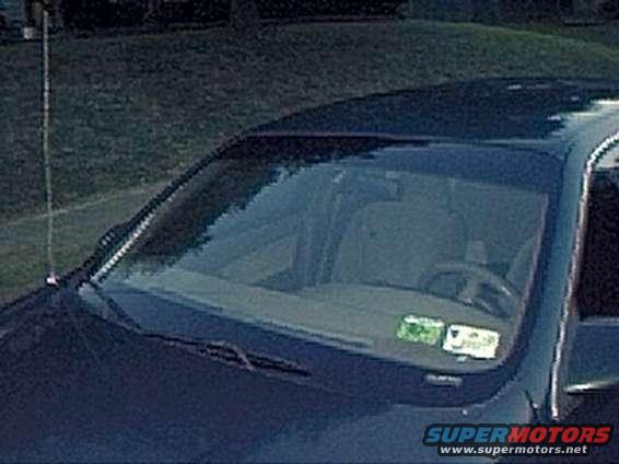 1994 Ford Taurus interior showing dashboard, steering wheel, and windshield with inspection stickers