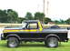 1979 Ford Bronco - This black 1978 Ford Bronco features distinctive yellow and orange racing stripes along its side.