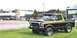 1979 Ford Bronco - This black 1979 Ford Bronco features distinctive yellow and orange side stripes and a brush guard on the front bumper.