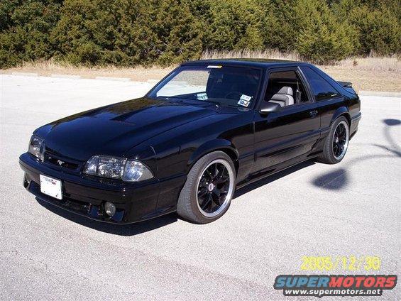 Black coupe with aftermarket wheels, 1993 model year