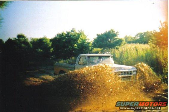 1979 Ford F-250 splashing through mud, front view