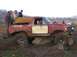 1978 Ford Bronco - This modified Ford Bronco is stuck on rocks while off-roading. Other vehicles are visible in the background.