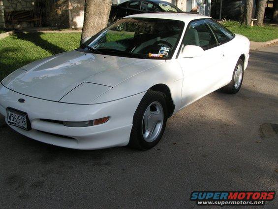 White 1995 Ford Probe coupe with pop-up headlights and a license plate reading W56-PXR