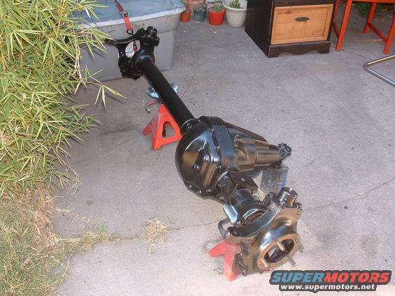 Black Jeep Dana 35 rear axle assembly on red jack stands outdoors