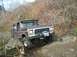 1978 Ford Bronco - A 1978 Ford Bronco navigates a challenging rocky trail, equipped with a winch for off-road recovery.