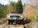 1978 Ford Bronco - 1978 Ford Bronco tackling a challenging off-road course with rocky obstacles.