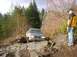 1978 Ford Bronco - A gray pickup truck is shown navigating a challenging rocky off-road trail, with a person observing the action.