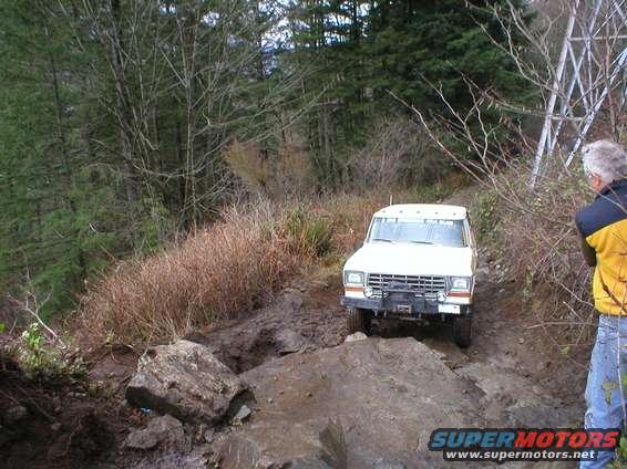 White 1978 Ford Bronco on a muddy, rocky trail