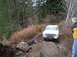 1978 Ford Bronco - A white 1978 Ford Bronco navigates a challenging muddy and rocky off-road course.