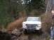 1978 Ford Bronco - 1978 Ford Bronco navigating a challenging muddy and rocky off-road trail.