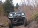 1978 Ford Bronco - Off-road vehicle navigating a rocky path, equipped with a front winch. Likely a 1978 Ford Bronco.