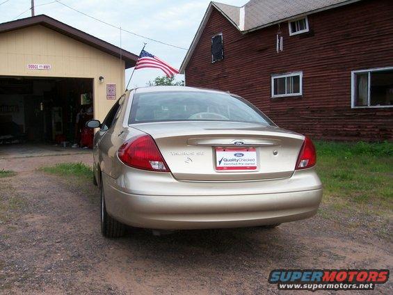 Gold 2000 Ford Taurus rear view with 'Quality Checked' license plate frame