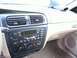 2000 Ford Taurus - Dashboard of a 2000 Ford Taurus, the center console with radio and climate controls, and air vents above.