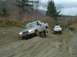 1978 Ford Bronco - Two trucks navigate a challenging dirt terrain on an overcast day.
