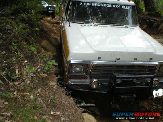 White 1978 Ford Bronco navigating a dirt trail with another Bronco visible behind it