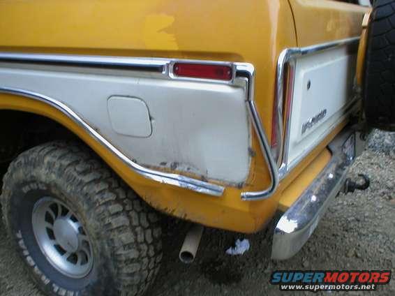 1978 Ford Bronco rear quarter panel with chrome trim and a white insert