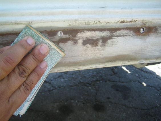 Rock slider being sanded with sandpaper
