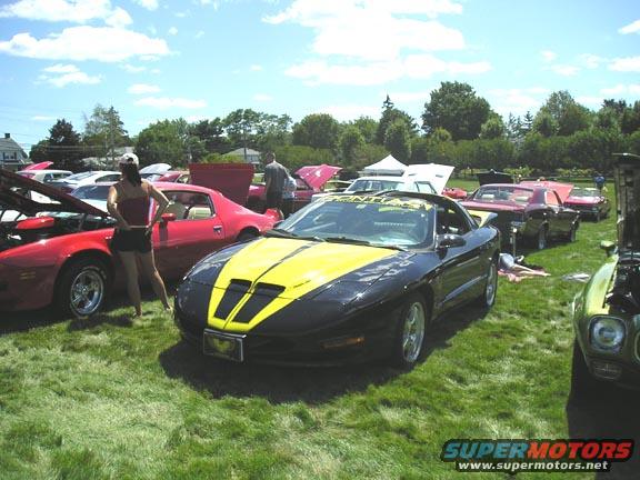 Black and yellow 1994 Pontiac Firebird with yellow racing stripes on hood