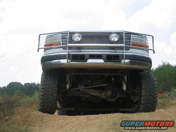 Front view of a lifted 1996 Ford Bronco with a chrome brush guard and large off-road tires
