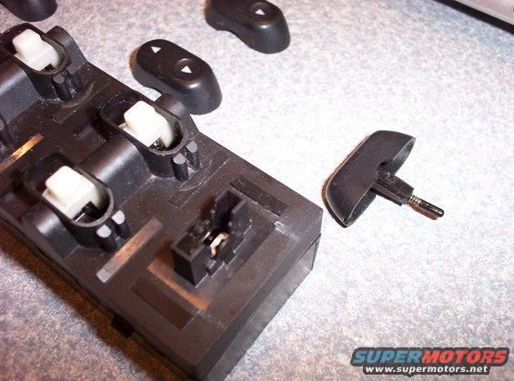 Window switch assembly with detached button