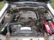 1988 Ford Thunderbird - The engine compartment of a car is shown with various components and hoses.