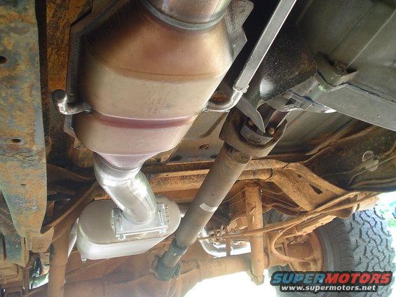 Underside view of vehicle showing exhaust, catalytic converter, driveshaft, and rear axle