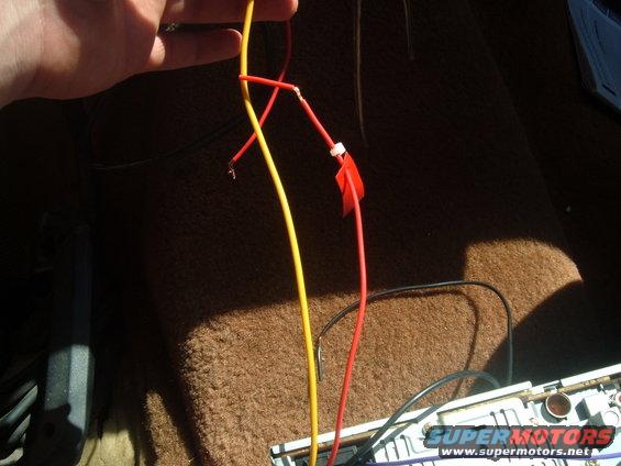Red and yellow wires being connected to a car stereo