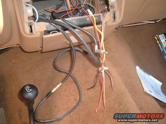 1988 Ford Bronco interior showing exposed radio wiring and 4x4 shifter