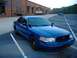 1998 Ford Crown Victoria - A blue 1998 Ford Crown Victoria is parked in a lot with another car in the background.