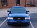1998 Ford Crown Victoria - Front view of a blue 1998 Ford Crown Victoria parked in a lot.