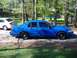 1998 Ford Crown Victoria - Side view of a blue 1998 Ford Crown Victoria sedan parked outdoors with another car visible in the background.