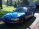 1998 Ford Crown Victoria - Blue 1998 Ford Crown Victoria sits in a driveway with a garage and trees behind it.