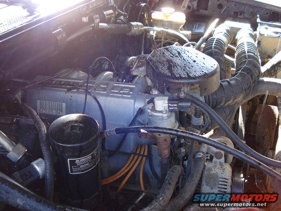 Engine bay with air intake, filter housing, and engine block visible. Part number 615585 847 on a silver component