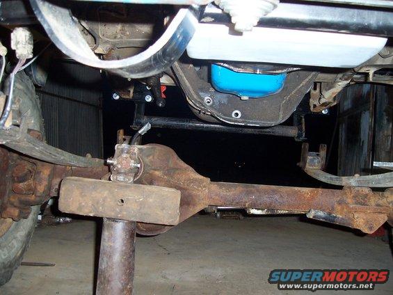 Rear axle assembly with U-joint and differential housing, supported by a stand
