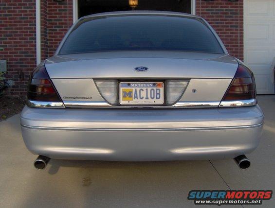 Silver 2002 Ford Crown Victoria sedan rear view, Michigan license plate MAC10B, tinted taillights, dual exhaust