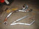 1969 Ford Mustang - Custom exhaust pipes and welding gear are assembled on a workshop floor, ready for installation.