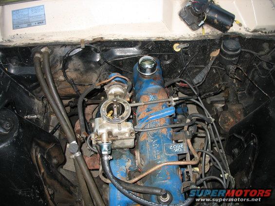 1966 Ford Ranchero engine bay with blue V8 engine and carburetor