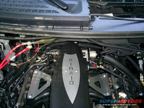 Engine bay view showing an AIRAID intake system with visible wiring and hoses