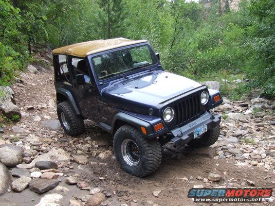 Blue 1997 Jeep TJ on a rocky trail
