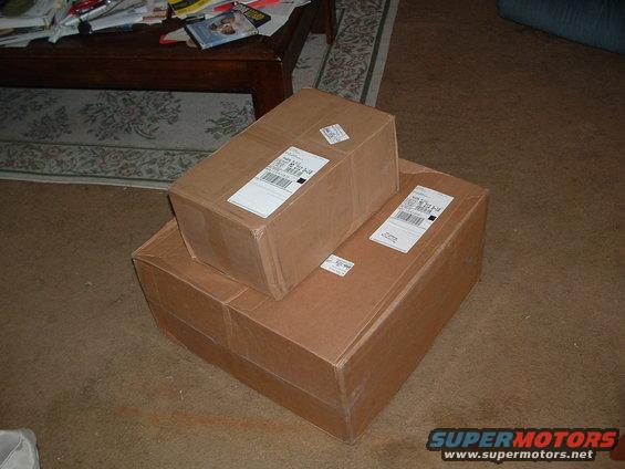 Two stacked cardboard boxes with shipping labels